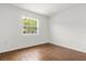 Bright bedroom features a window and wood-look tile flooring at 1062 Hidden Dr, Lakeland, FL 33809