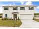 Two-story home with a white exterior, blue shutters, and well-maintained landscaping at 1062 Hidden Dr, Lakeland, FL 33809