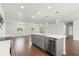 Open-concept kitchen with a center island, stainless steel appliances, and wood tile flooring at 1062 Hidden Dr, Lakeland, FL 33809
