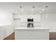 Clean kitchen with white cabinets, a center island, and modern stainless steel appliances at 1062 Hidden Dr, Lakeland, FL 33809