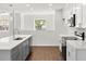 Modern kitchen with gray cabinets, stainless steel appliances, and wood tile flooring at 1062 Hidden Dr, Lakeland, FL 33809