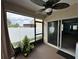 Enclosed lanai with ceiling fan, screen and sliding glass doors to the interior at 112 Lake Tracy Ct, Haines City, FL 33844