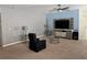 Cozy living room featuring neutral colors, a ceiling fan, and carpeted floors that create a welcoming atmosphere at 112 Lake Tracy Ct, Haines City, FL 33844