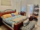 This bedroom includes a wooden bed frame, complementing pillows and stylish bench for added elegance at 1137 Cherry Valley Way, Orlando, FL 32828
