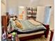 Cozy bedroom with a wooden frame bed, shelf and attached bathroom for convenience and comfort at 1137 Cherry Valley Way, Orlando, FL 32828