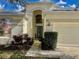 Inviting front entrance with a blue-trimmed door, stylish lighting, and well-kept landscaping at 1137 Cherry Valley Way, Orlando, FL 32828
