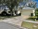 Traditional home with a large driveway, lush lawn, and mature shade trees at 1137 Cherry Valley Way, Orlando, FL 32828