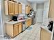 Functional kitchen featuring wooden cabinets, stainless steel appliances, and durable tile flooring at 1137 Cherry Valley Way, Orlando, FL 32828