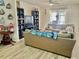 Cozy living room with wood floors, a large sectional sofa, and sliding glass doors at 1137 Cherry Valley Way, Orlando, FL 32828