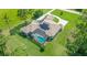 Aerial view of a home featuring an outdoor pool, a screened in patio, and solar panels at 12177 Gray Birch Cir, Orlando, FL 32832