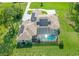 Aerial view of the home, showcasing solar panels and a screened-in pool area at 12177 Gray Birch Cir, Orlando, FL 32832