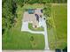 Aerial view of a large home with lush landscaping, a long driveway, a pool, and a large yard at 12177 Gray Birch Cir, Orlando, FL 32832