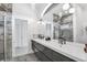 Elegant bathroom with a double vanity, marble accents, and modern lighting fixtures at 12177 Gray Birch Cir, Orlando, FL 32832