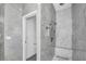 This modern bathroom features a marble tiled shower with a rainfall shower head and mosaic tile flooring at 12177 Gray Birch Cir, Orlando, FL 32832