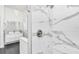 Modern bathroom featuring a walk-in shower with marble tiles and sleek fixtures at 12177 Gray Birch Cir, Orlando, FL 32832