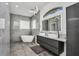 This gorgeous bathroom is equipped with double sinks, a modern soaking tub, and a privacy window at 12177 Gray Birch Cir, Orlando, FL 32832