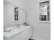 Bright bathroom featuring a modern vanity with sleek fixtures and a large mirror at 12177 Gray Birch Cir, Orlando, FL 32832