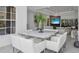 Modern dining room featuring a white table with seating for eight, open to living room at 12177 Gray Birch Cir, Orlando, FL 32832