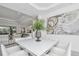 Bright dining area features a modern table, stylish chairs, and contemporary artwork, perfect for entertaining and Gathering meals at 12177 Gray Birch Cir, Orlando, FL 32832