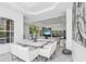 This bright dining room is decorated with modern furnishings, bright white colors, and a view to the living area at 12177 Gray Birch Cir, Orlando, FL 32832