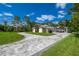 Wide driveway leading to a three-car garage and a well-maintained lawn at 12177 Gray Birch Cir, Orlando, FL 32832