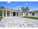 This single-story home boasts a sprawling driveway, manicured lawn, covered porch, and elegant entryway at 12177 Gray Birch Cir, Orlando, FL 32832