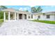 Elegant home featuring a hanging chair on the front porch and a large paved driveway at 12177 Gray Birch Cir, Orlando, FL 32832
