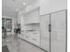 Modern kitchen with sleek white cabinetry, integrated appliances, and minimalist design at 12177 Gray Birch Cir, Orlando, FL 32832