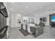 Spacious kitchen with an island, stainless steel appliances, and modern white cabinetry at 12177 Gray Birch Cir, Orlando, FL 32832
