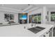 Sleek kitchen with stainless sink and modern faucet, overlooking the living room and outdoor living space at 12177 Gray Birch Cir, Orlando, FL 32832