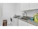 Well-equipped laundry room with modern appliances and ample counter space at 12177 Gray Birch Cir, Orlando, FL 32832