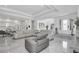 Bright and open living room with large sofas and porcelain flooring, open to kitchen at 12177 Gray Birch Cir, Orlando, FL 32832