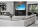 Cozy living room with a modern fireplace, a large TV, and stylish seating area at 12177 Gray Birch Cir, Orlando, FL 32832