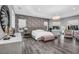 This elegant bedroom features a tray ceiling, decorative lighting, wood floors, and large windows at 12177 Gray Birch Cir, Orlando, FL 32832