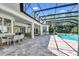 Expansive outdoor patio with a screened-in pool and ample seating areas at 12177 Gray Birch Cir, Orlando, FL 32832