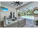 Comfortable outdoor seating area with a swing chair overlooking the screened-in pool at 12177 Gray Birch Cir, Orlando, FL 32832