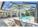 Inviting screened-in pool area with lounge chairs and an umbrella, perfect for relaxation at 12177 Gray Birch Cir, Orlando, FL 32832