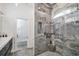 Luxurious walk-in shower featuring stylish marble tiling and a built-in shower bench at 12177 Gray Birch Cir, Orlando, FL 32832