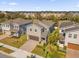 An aerial view shows the property has a brick paver driveway and lush landscaping in a vibrant neighborhood at 1252 Ash Tree Cv, Casselberry, FL 32707