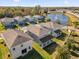 A high aerial view highlighting the neighborhood homes, pond with fountain, and surrounding greenery at 1252 Ash Tree Cv, Casselberry, FL 32707