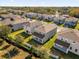 Aerial view featuring backyards of gray homes with green lawns and covered patios in a well-maintained community at 1252 Ash Tree Cv, Casselberry, FL 32707
