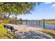 Scenic community dock with black metal railings offering tranquil water views and a relaxing bench at 1252 Ash Tree Cv, Casselberry, FL 32707