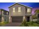 Charming two-story home boasts neutral stucco, a two-car garage, and professionally landscaped front yard at 1252 Ash Tree Cv, Casselberry, FL 32707