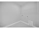 This is a small laundry room with white walls, tile floors, and a wire shelf at 1252 Ash Tree Cv, Casselberry, FL 32707