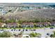 Scenic aerial view showing the community buildings, trees, and beautiful lake in the distance at 13829 Timberland Dr # 204, Orlando, FL 32824