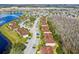 Scenic aerial view of community buildings, trees, and a lake nearby at 13829 Timberland Dr # 204, Orlando, FL 32824