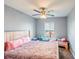 Bedroom featuring a ceiling fan, large window, and comfortable furnishings at 13829 Timberland Dr # 204, Orlando, FL 32824