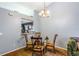 Cozy dining area features a glass table, seating for four, and views into the kitchen at 13829 Timberland Dr # 204, Orlando, FL 32824