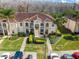 Inviting condo building featuring lush landscaping, red tile roof, and convenient parking spaces at 13829 Timberland Dr # 204, Orlando, FL 32824