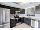 Modern kitchen featuring stainless steel appliances, sleek black cabinets and an undermount sink at 13829 Timberland Dr # 204, Orlando, FL 32824